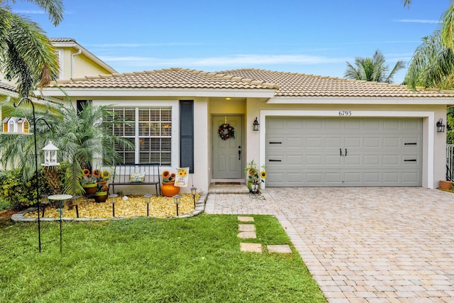 view of front of home featuring a garage and a front lawn