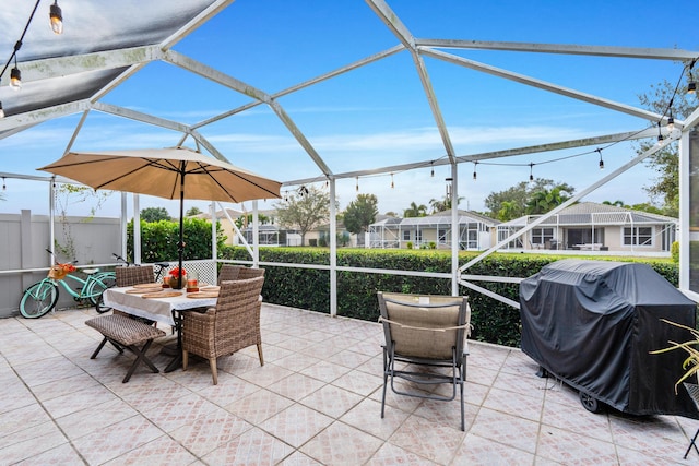 view of patio / terrace with glass enclosure and a grill