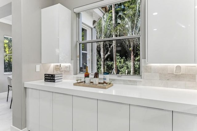 bathroom with vanity, a wealth of natural light, and crown molding