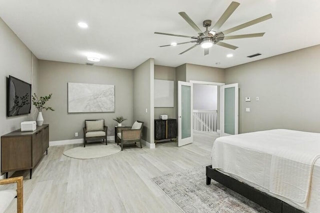 bedroom with french doors, ceiling fan, and light hardwood / wood-style flooring