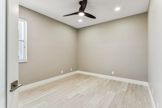 spare room with ceiling fan and light wood-type flooring