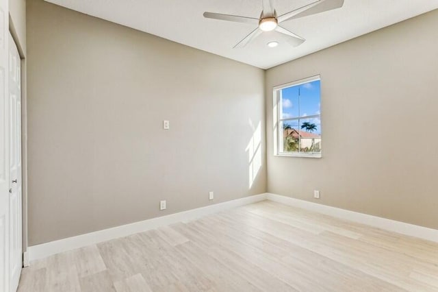 empty room with ceiling fan and light hardwood / wood-style floors