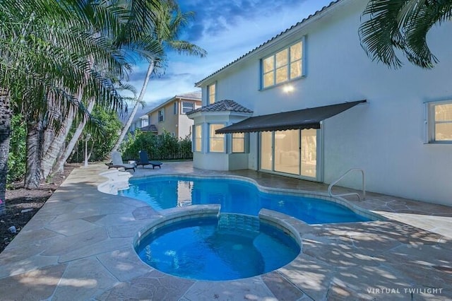 view of pool with an in ground hot tub and a patio