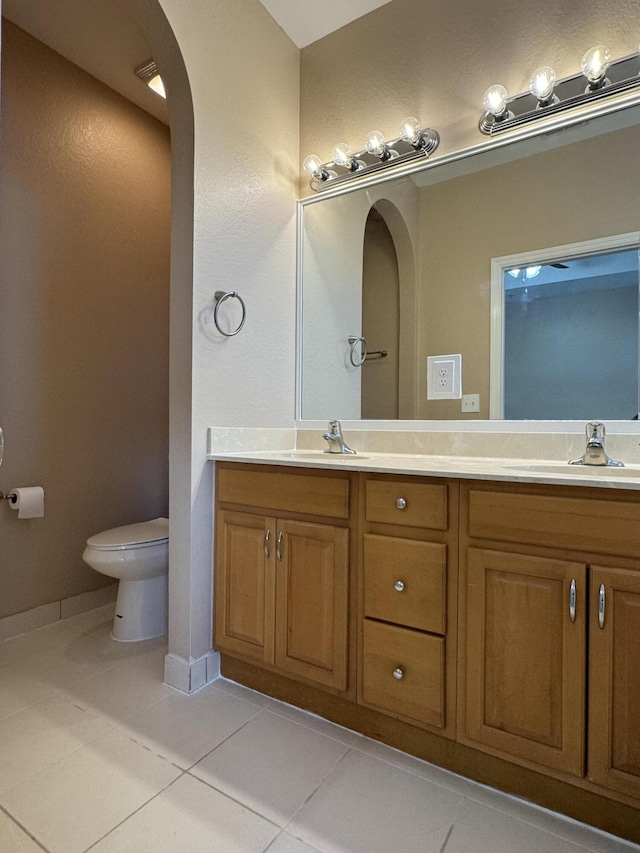 bathroom with tile patterned floors, vanity, and toilet