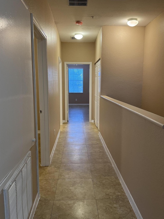 corridor featuring light tile patterned floors