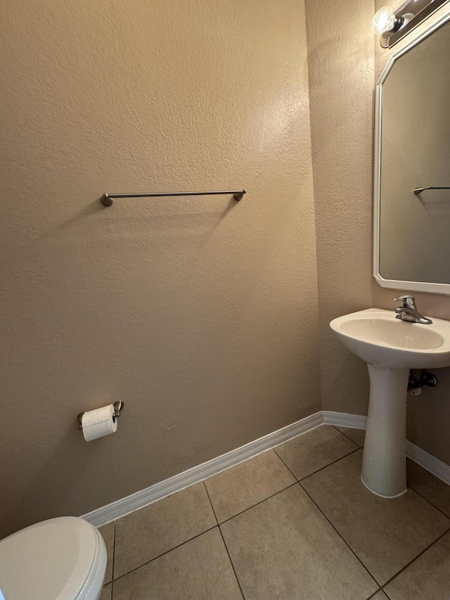 bathroom featuring tile patterned floors and toilet