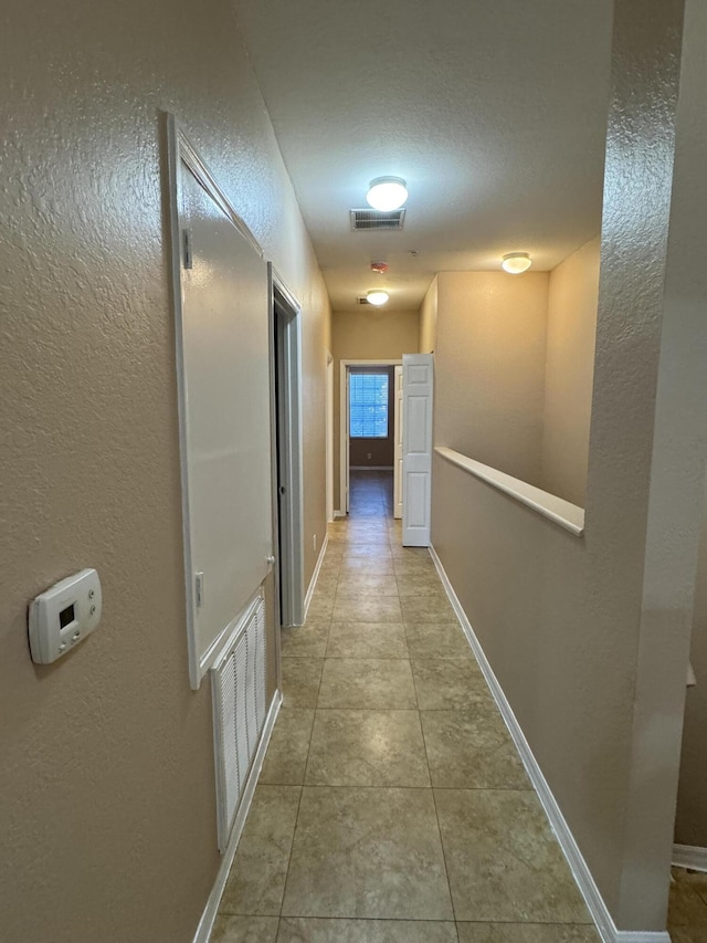 hallway with a textured ceiling