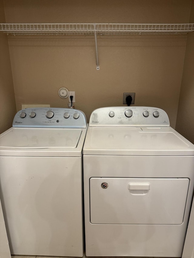 washroom featuring washing machine and dryer and ornamental molding