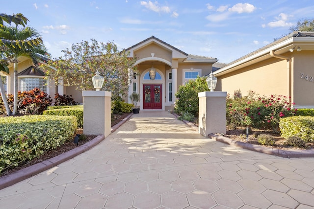 view of exterior entry featuring french doors