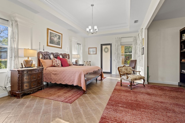 bedroom featuring a raised ceiling and an inviting chandelier