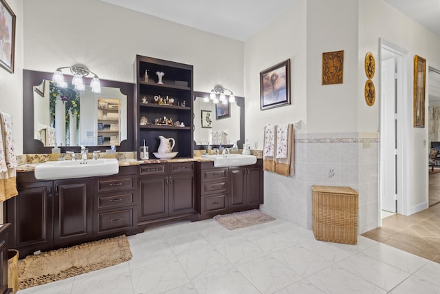 bathroom with tile walls and vanity