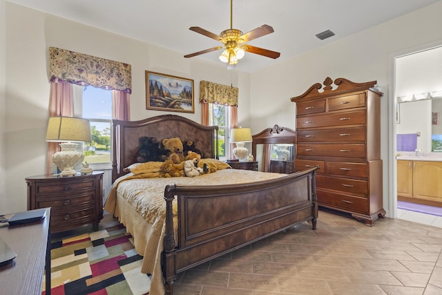 bedroom with ceiling fan and ensuite bath