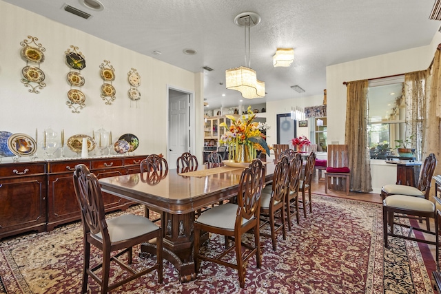 dining space with a textured ceiling