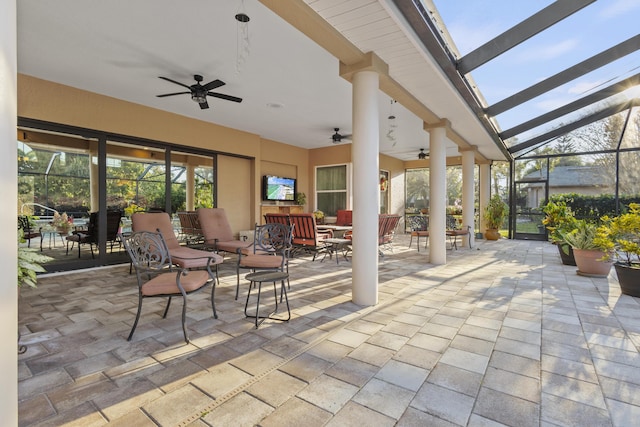 view of patio with ceiling fan and a lanai