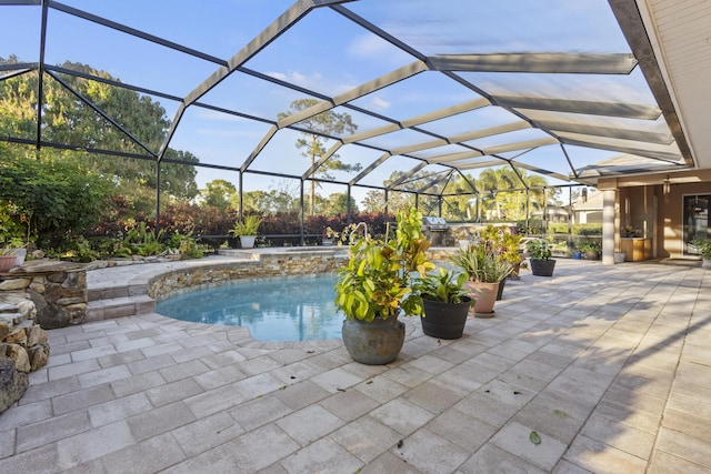 view of swimming pool with a lanai and a patio area