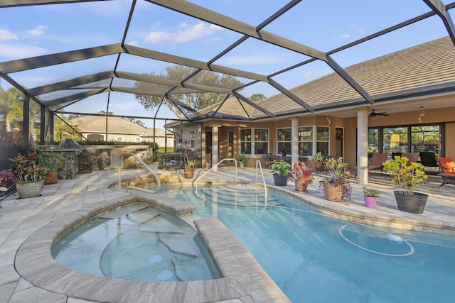 view of swimming pool featuring a lanai, a patio, ceiling fan, and an in ground hot tub