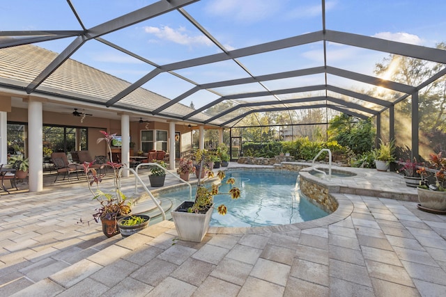 view of swimming pool featuring ceiling fan, a lanai, outdoor lounge area, and a patio area