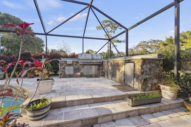 view of patio with grilling area, glass enclosure, and area for grilling