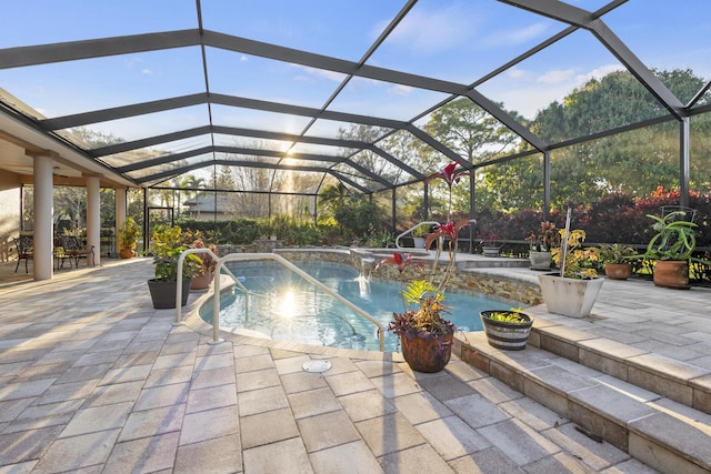 view of pool with a patio and glass enclosure