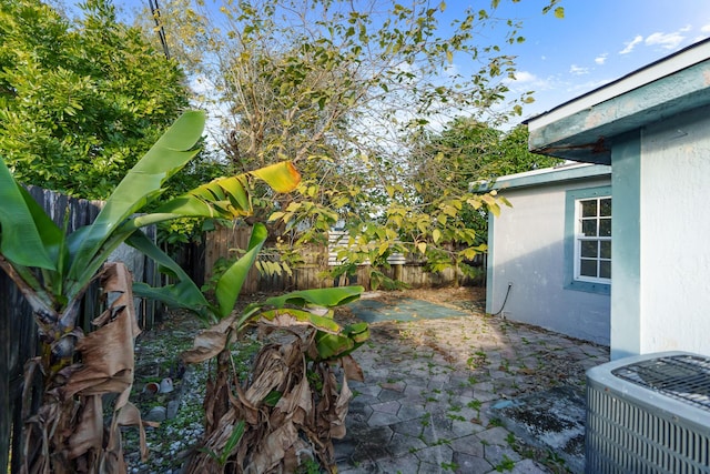 view of yard featuring cooling unit and a patio