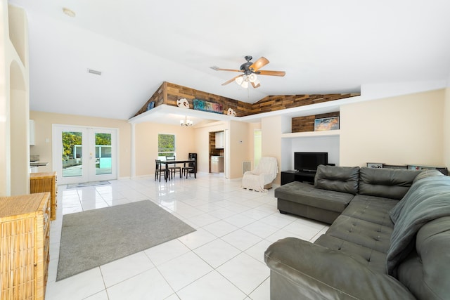 living room featuring ceiling fan, french doors, light tile patterned floors, and lofted ceiling