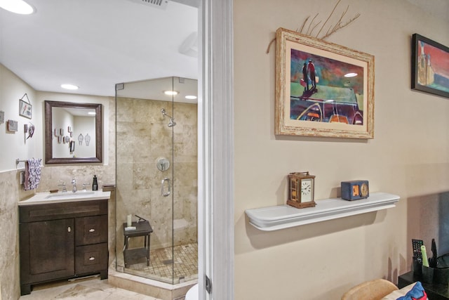 bathroom featuring vanity and a shower with shower door