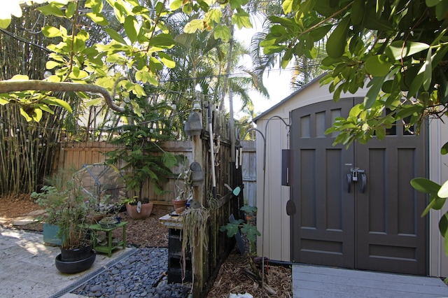 view of gate featuring a storage unit