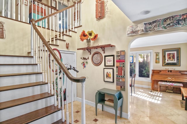 staircase featuring tile patterned flooring