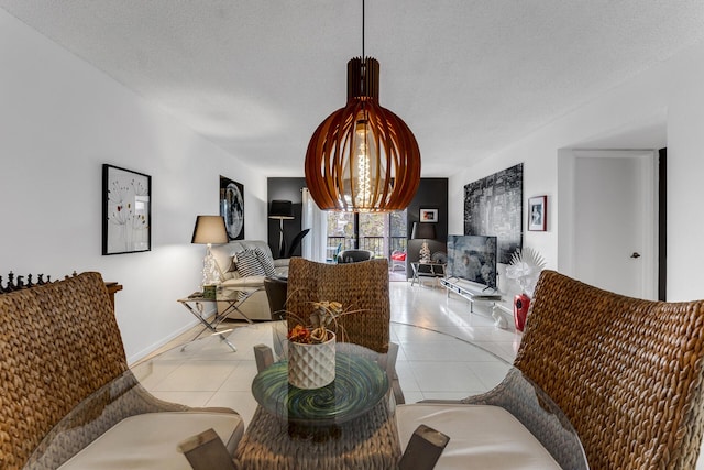 tiled dining room featuring a textured ceiling