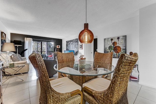 dining room featuring a textured ceiling and light tile patterned floors