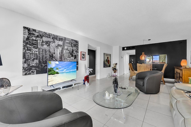 tiled living room featuring a textured ceiling