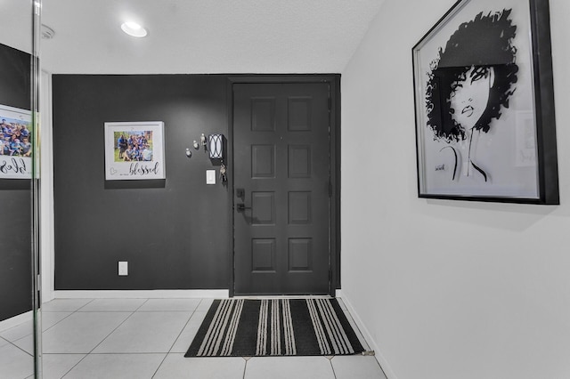 tiled foyer with a textured ceiling