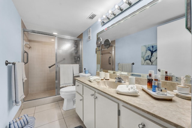 bathroom featuring toilet, tile patterned flooring, walk in shower, and vanity