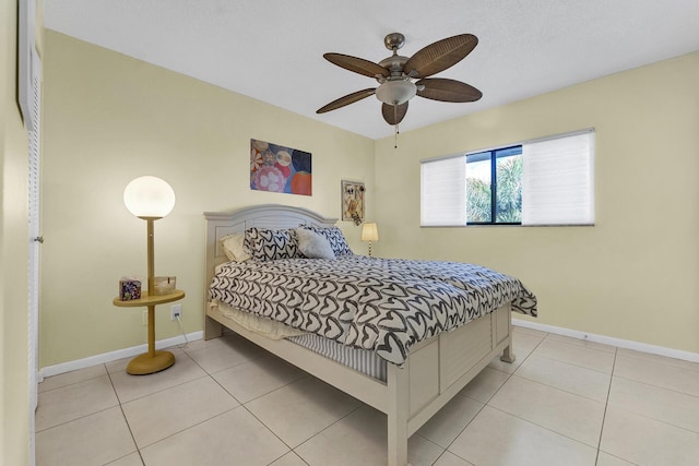 bedroom with ceiling fan and light tile patterned floors