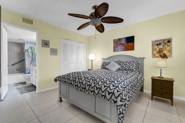 tiled bedroom with a closet, ensuite bathroom, and ceiling fan