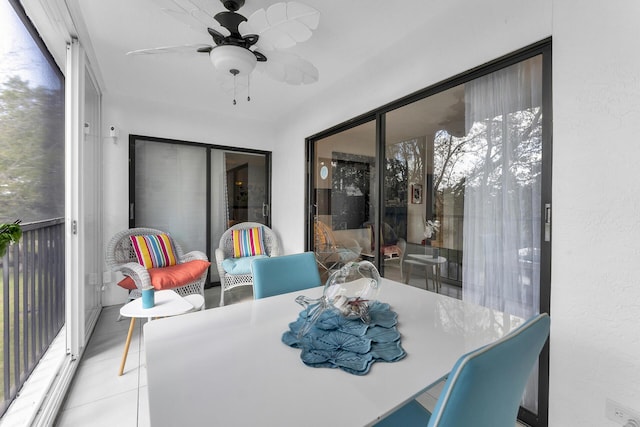 sunroom featuring ceiling fan