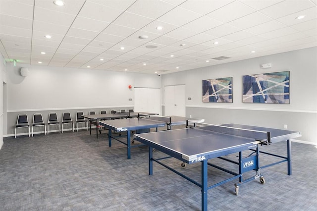 recreation room featuring a paneled ceiling and carpet flooring