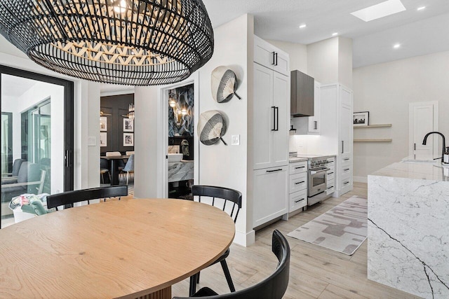 dining space featuring light hardwood / wood-style floors and sink