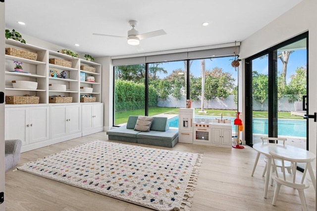 sitting room with light hardwood / wood-style flooring and ceiling fan