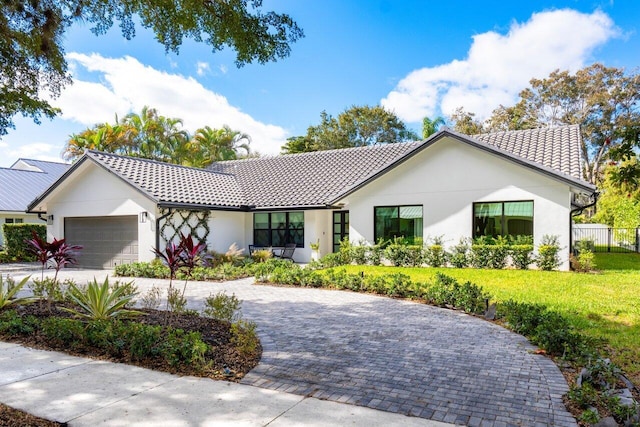 view of front of home featuring a garage and a front yard