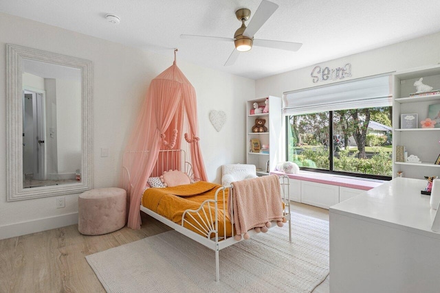 bedroom featuring light wood-type flooring and ceiling fan