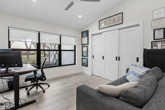 home office featuring ceiling fan, vaulted ceiling, and light wood-type flooring