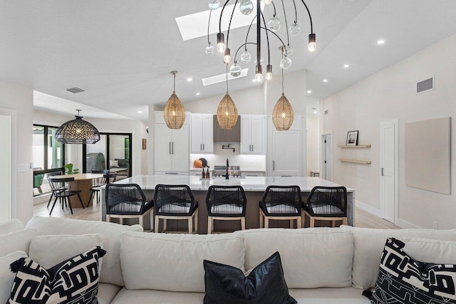 living room featuring vaulted ceiling and light wood-type flooring