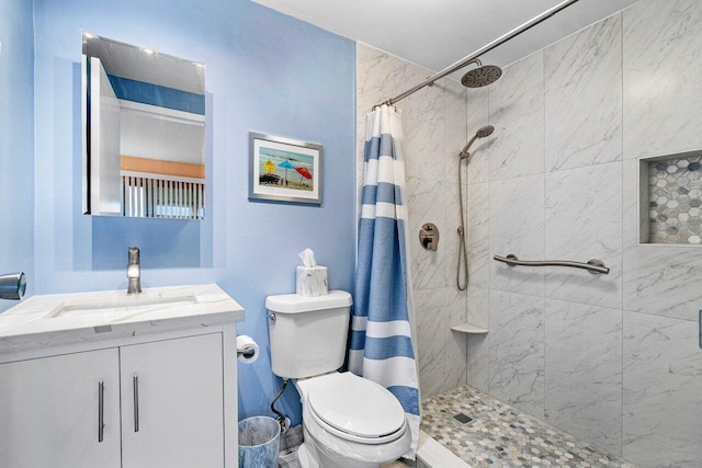 bathroom with a shower with curtain, vanity, and toilet