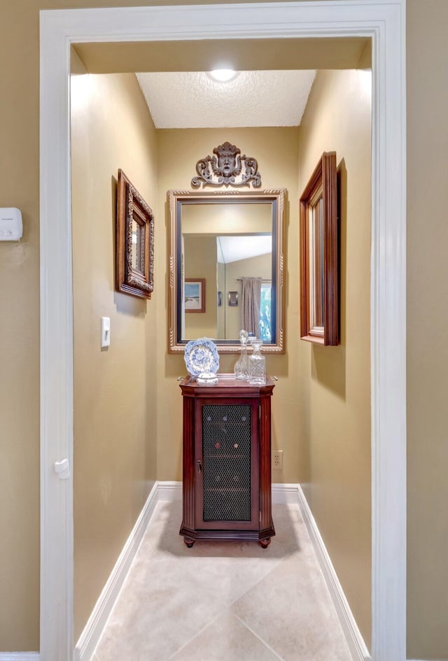 hall with light tile patterned flooring