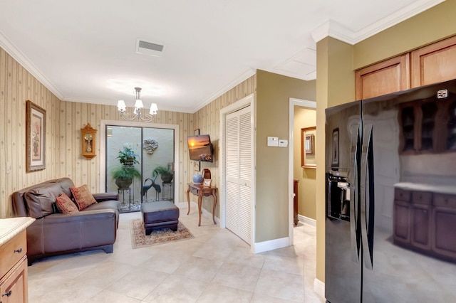 interior space with light tile patterned floors, wood walls, an inviting chandelier, and ornamental molding