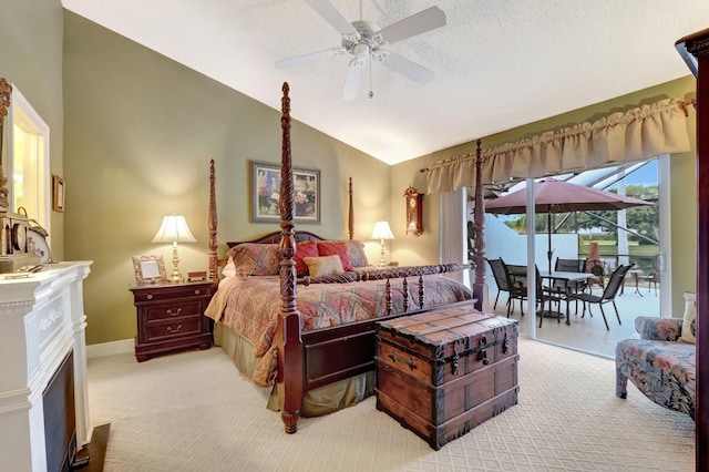 carpeted bedroom with ceiling fan, vaulted ceiling, and a textured ceiling