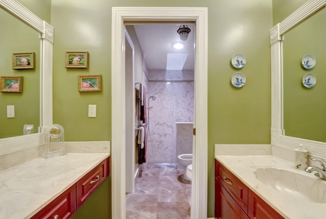 bathroom featuring a shower with shower door, vanity, a bidet, and toilet