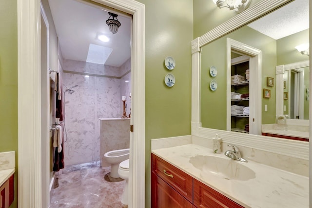 bathroom featuring toilet, vanity, and a bidet