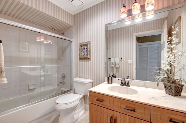 full bathroom with enclosed tub / shower combo, vanity, crown molding, and toilet